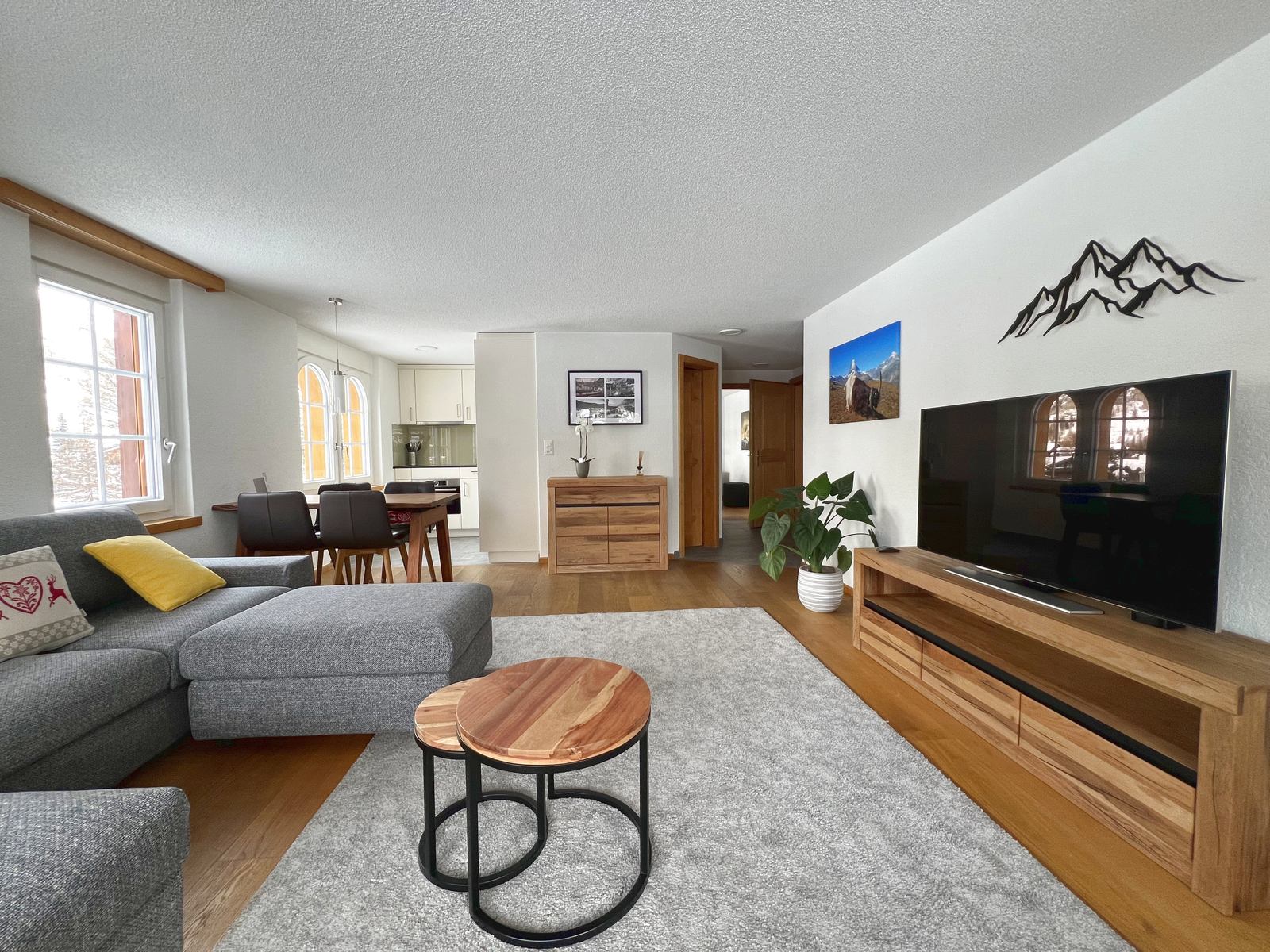 Wohnbereich des Apartments mit Sofa, Fernseher und Essplatz